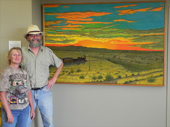 Laurie and Chuck pose with the mural